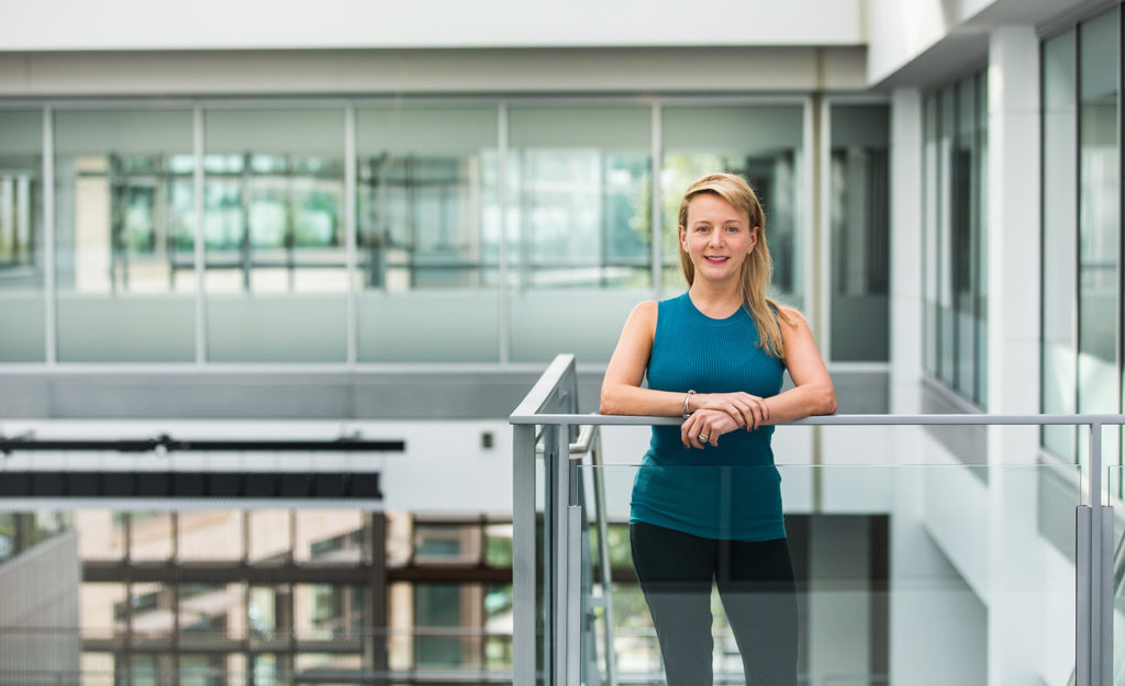 Portrait of Angela Mills in an office building with natural light