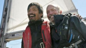 Mitsuhiro Iwamoto, a blind Japanese sailor, celebrates with his navigator Doug Smith of the U.S. after successfully completing a near two-month, non-stop voyage from San Diego to Fukushima Prefecture on the Pacific Ocean, upon their arrival at Onahama port in Iwaki, Fukushima prefecture, Japan, in this photo taken by Kyodo April 20, 2019. (Mandatory credit Kyodo/via REUTERS)