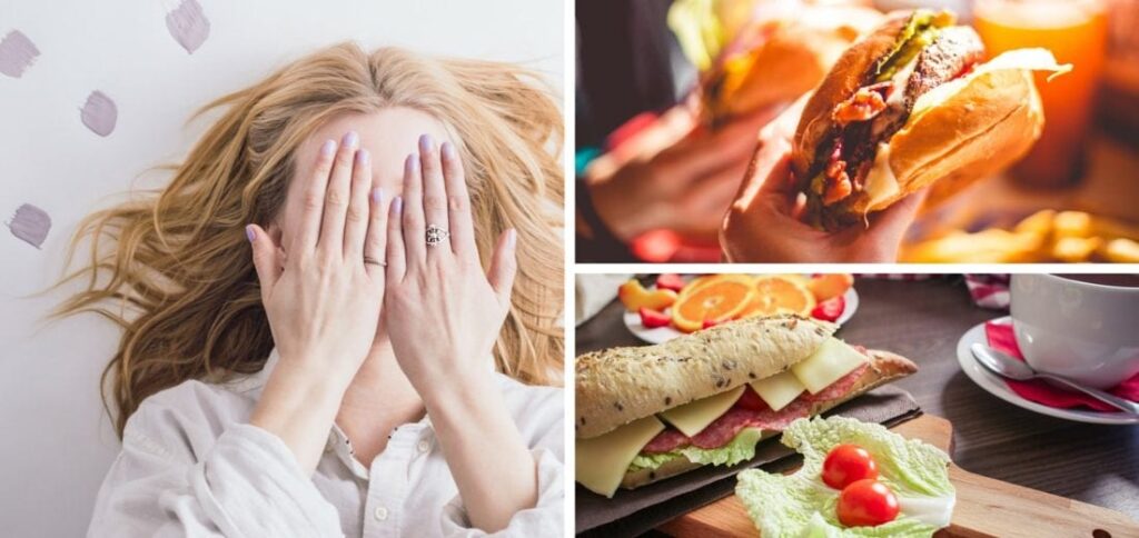 A woman covering her face with her hands, a delicious looking burger, and a cold-cuts sandwich with other appetizers on a table.