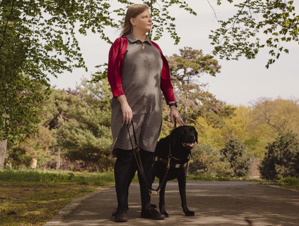 Chancey Fleet Standing next to her service dog