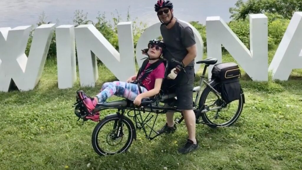 Ron with Daughter on an adaptive bike