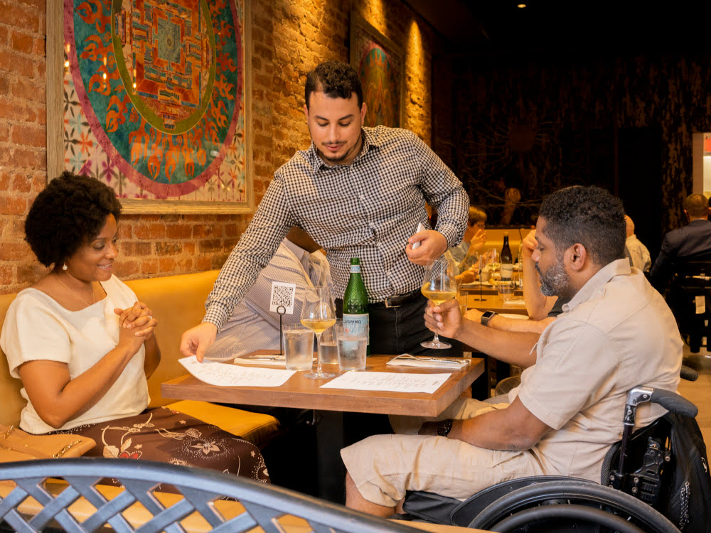 picture of a man in a wheelchair having drinks with a woman in "contento" restaurant 