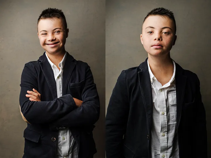 Picture of a young man with down syndrome posing for the picture.