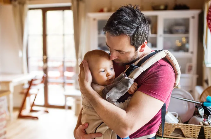 Picture of a father holding his baby.