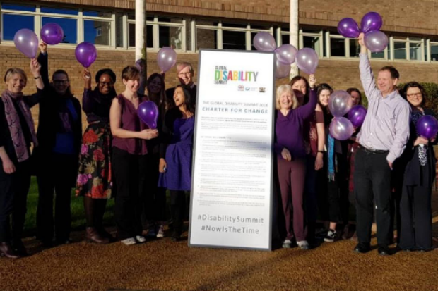 Picture of people celebrating disability purple light up day.