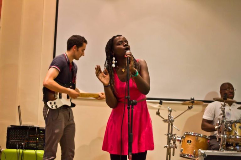 Picture of Crystal Asige singing.