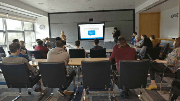 Picture of a group of people in a meeting office having a discussion.