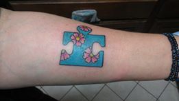 Picture of a tattoo on a women's arm that represents autism.
