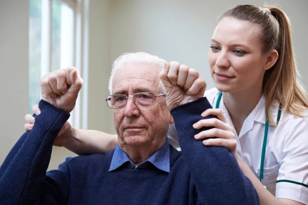 Picture of an older man getting checked at the doctors.