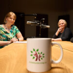 Women Gathered a table with an A Life Worth Living Mug in the foreground