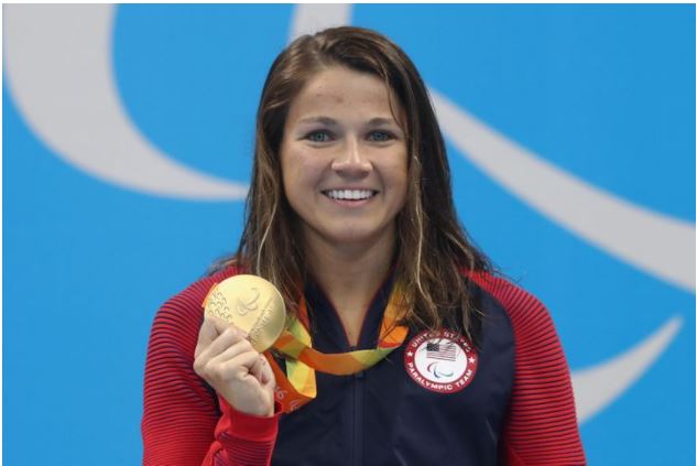 Picture of Becca Meyers holding the  400m Freestyle S13 gold medal.