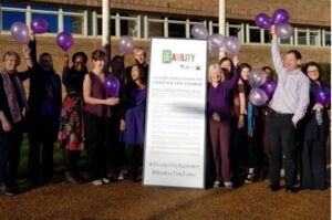 Picture of people celebrating disability purple light up day.