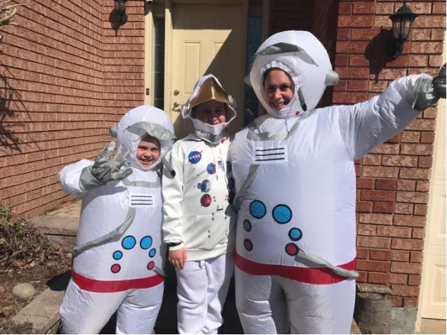 Picture of Poppy Anderson, left, Atlas Anderson, centre, and mom Kat Anderson dress up in costume for a neighborhood stroll.