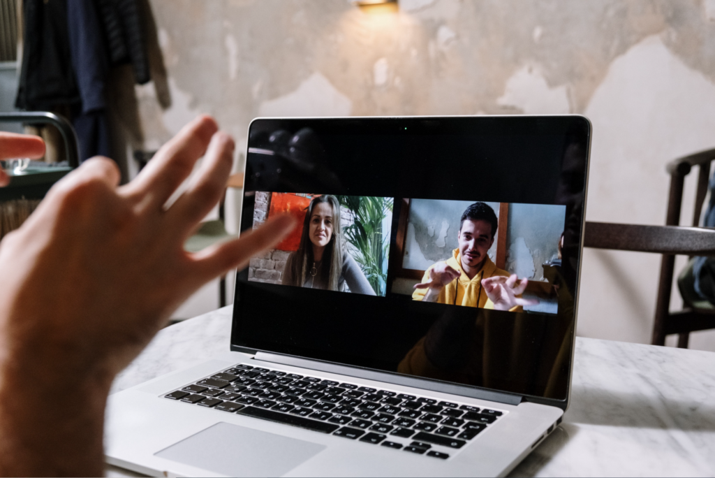 Picture of people doing sign language on facetime.