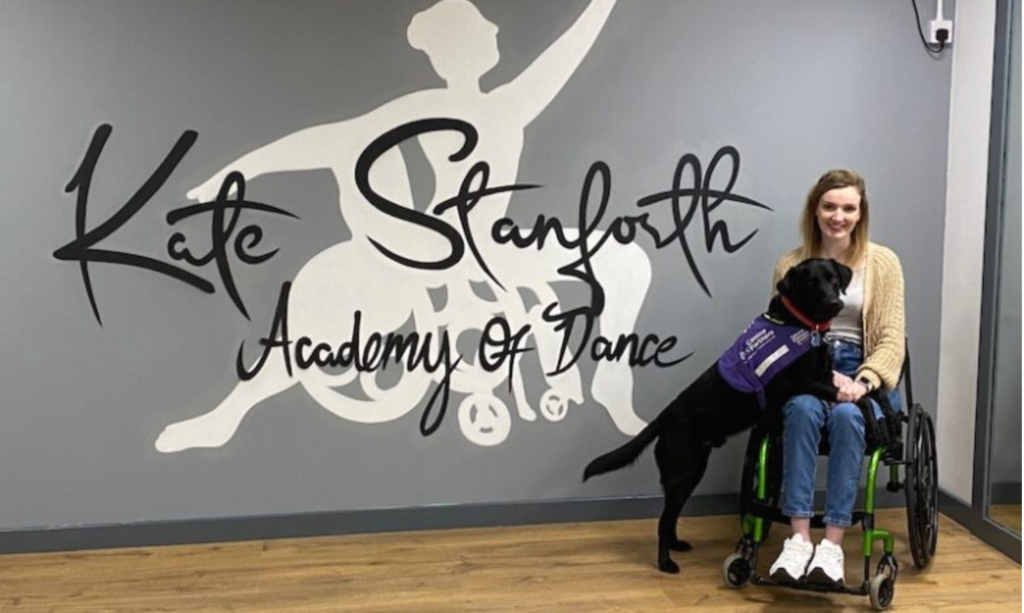 Picture of Kate Stanforth and her service dog.