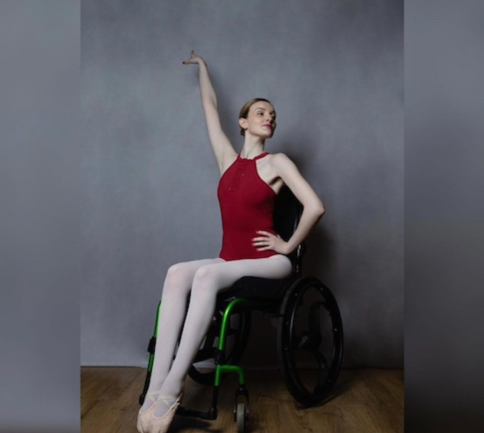 Picture of Kate Stanforth in her wheelchair wearing a dance outfit.