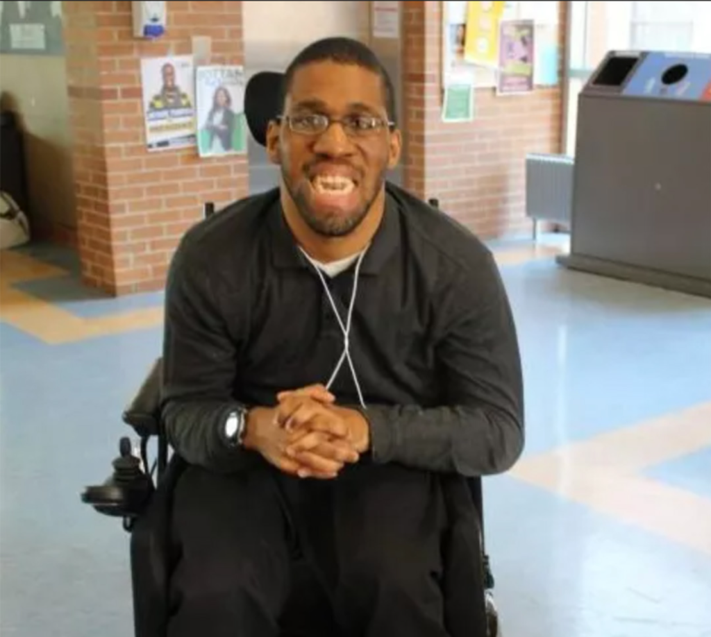 Image of Kevin McShan in his wheelchair sitting in St. Clair College.