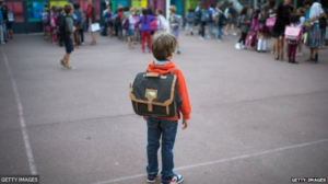 Picture of a kid with his backpack on.