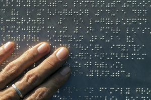 Image of fingers on braille.