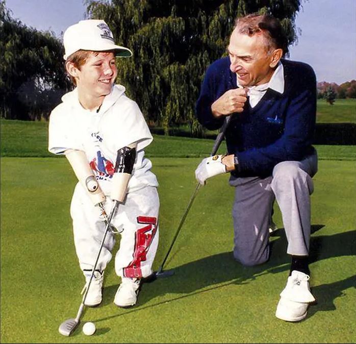 Cliff Chadderton is shown with Child Amputee Program member Chris Koch.