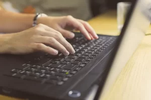 Person typing on a laptop.