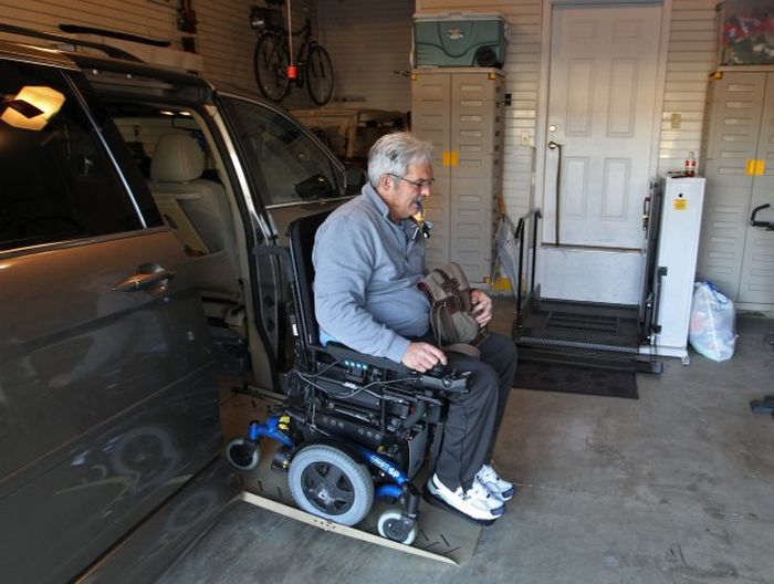 Dr. Rummel exiting his mini-van with a chair lift.