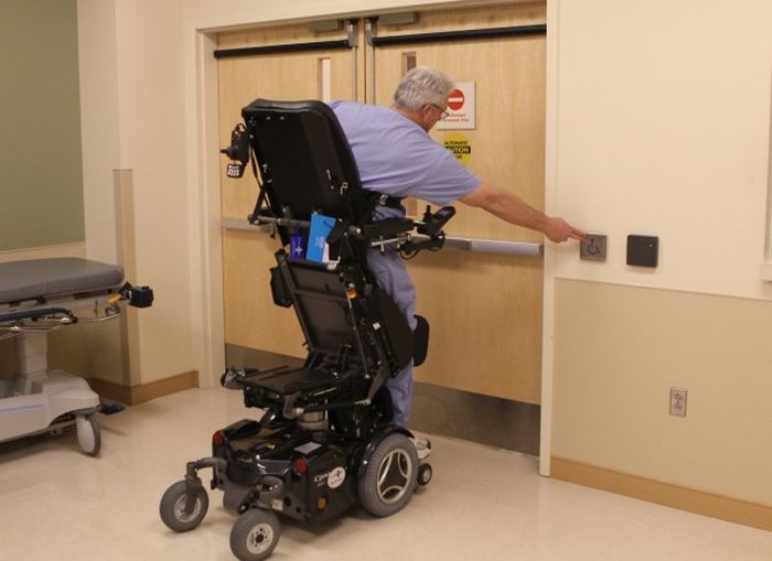 Dr. Rummel passing through an automated door while in his standing wheel chair