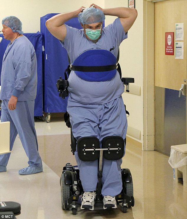 Dr. Rummel in a standing wheel chair preparing for surgery.